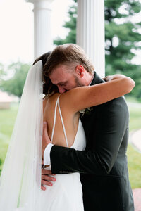 An intimate, close-up moment of a couple embracing after their first look, illustrating the natural unfolding of emotion during a wedding weekend.