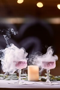 Fierce Vanity Bartending - Two martini glasses emitting smoke, showcasing the captivating artistry and flair of our preferred vendors