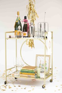 cart with champagne and books
