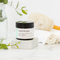 Styled product photography of skincare jar photographed with soft light and natural elements for clean, editorial branding