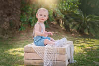 Baby sitting outdoors in natural light in New Bern North Carolina
