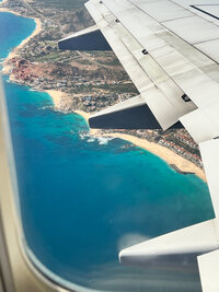 Photo taken from an airplane flying over a beachfront resort area in the Caribbean or Mexico