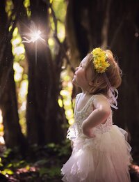 Jacksonville, FL photographer capturing Sassy young princess in O’Fallon, Illinois as she poses with her hand on her hip as a glowing fairy hovers above her during a signature.fairy adventure session.