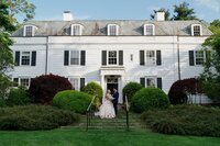 bride and groom posing in front of Darien community association wedding venue in Connecticut