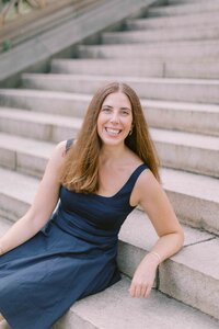 Woman leaning back on stairs and smiling