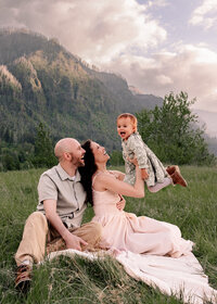 Family of 3 playing together during family portraits at Hamilton Mountain in the Columbia River Gorge.