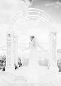 Bride twirling her cathedral veil, black and white image