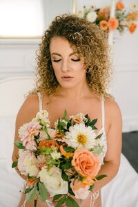 Bridal boudoir session with lush peach dahlia and ivory bouquet by Flowergirl Cville, Charlottesville wedding florist | Photo by Lyn Waldrop Photography