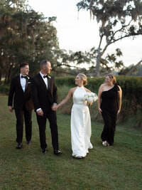 Bride and groom walking outside a historic mansion in Charleston, South Carolina