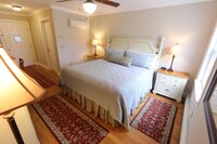 King bed guest room at Crossed Keys Inn with cozy linens desk and full bath for overnight wedding guests