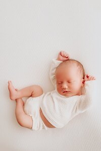 Tender newborn and toddler sibling moment captured in a studio session
