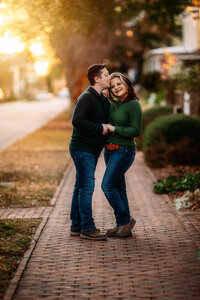 Husband kissing his wife at golden hour during a family session in New Bern North Carolina