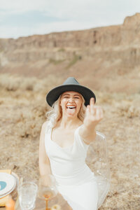 bride smiling holding up her ring finger