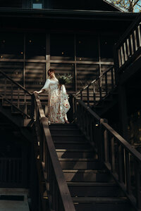 Newly married couple standing outside Airbnb cabin in North Georgia mountains for cinematic photos. Photos by Crimson Conure Photography based in Kennesaw, Georgia and Denver, Colorado