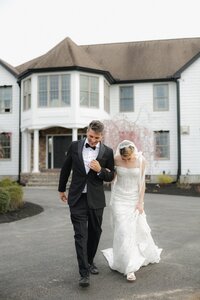 Couple walking through historic Massachusetts wedding venue captured with an editorial and candid approach