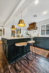 Kitchen island with bar height seating in this three-bedroom, two-bathroom vacation rental home featured on Chip and Joanna Gaines' Fixer Upper located in downtown Waco, TX.
