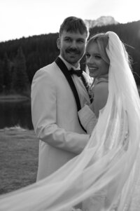 Candid moment of elopement bride and groom laughing in Banff National Park.