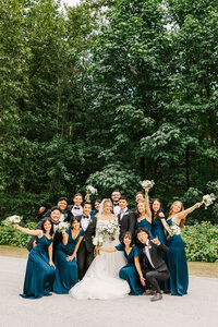 Bridal party cheering around bride and groom