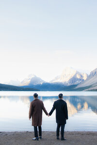 couple holding hands at a lake
