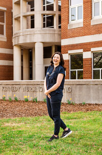 MTSU Nursing senior in blue scrubs outside of Kennedy Nursing Building