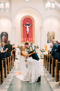 couple kissing in church after wedding