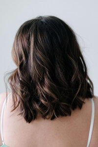 Stylist finishing off the Austin look with gentle iron work to set the wave and hold the shape all day
