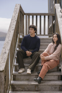 Navy crewneck and blush knit set styled on weathered wooden steps