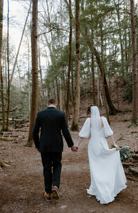 Joyful portrait of bride and groom  at the fall forest elopement in the Smoky Mountains.