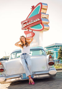 Senior portrait at Sunliner Diner in Gulf Shores, Alabama — sitting on the trunk of a white
classic car with the diner sign in the background.