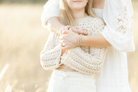 Close up photo of a mother holding her daughter for family photos in a DFW park.