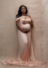 studio maternity photoshoot with a peach theme