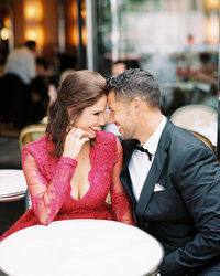 Upscale couple laughs at Paris bistro table