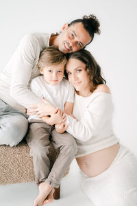 Family hugging during studio maternity session Miami, fine art photographer