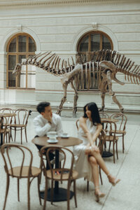 Couple enjoying coffee in National Museum in Prague captured by couple photographer