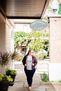 Mahlia walking through Winter Garden Village on a sunny day near Centennial Plaza