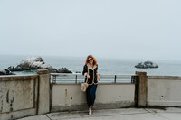 crimson conure photography's georgia and colorado based owner, Kyra Eybelman, posing for camera for a photo shoot in san fransisco in california for a photo session.