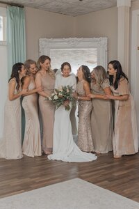 Bride with Bridesmaids in Champagne bridal dresses | Wedding at The White Room St. Augustine | Phavy Photography, Wedding Photographer in St. Augustine