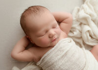 Baby newborn boy posing for newborn photoshoot in Syracuse New York