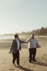 Two men dancing together on the Oregon Coast after Eloping