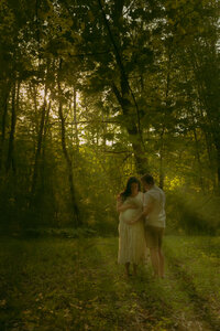 A newlywed couple looks at eachother with big smiles as they celebrate their marriage in front of a rustic cabin