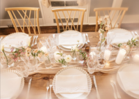 Curated tablescape with votive candles and floral centerpieces. Florals: Flowergirl Cville. Venue: Maison Charlottesville. Photography: Amy Mitchell.