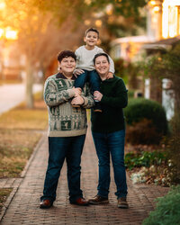 Dad posing with his two sons during a downtown New Bern family photography session