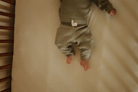 newborn feet in crib
