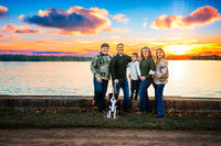 Family standing by the water at sunset in New Bern North Carolina