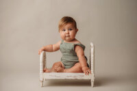 Baby looks at the camera during Baby Milestone Portrait Session at Holy City Babies Portrait Studio in Charleston, SC.