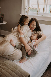 Mom laughing with children during maternity photoshoot at Maison Charlottesville.