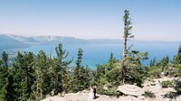 Bride and groom portrait at the top of a mountain with panormaic views of Lake Tahoe at Heavenly