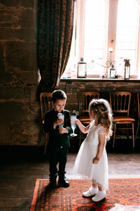 elopement at pengersick castle children share a drink together captured by colourful documentary photographer