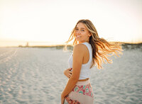 Senior portrait on the beach in Gulf Shores, Alabama — hair flip while walking toward the
camera.