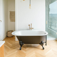 Photo of a Home Staging with a black claw foot bathtub and light wood floors.